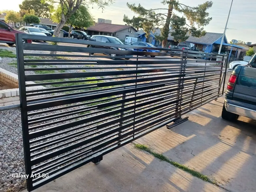 Steel rail fence along a driveway