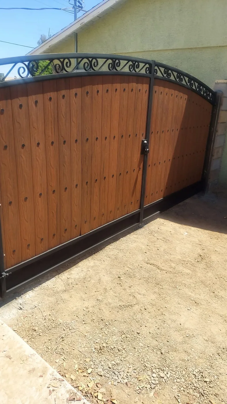 Arched cedar gate with black steel frame