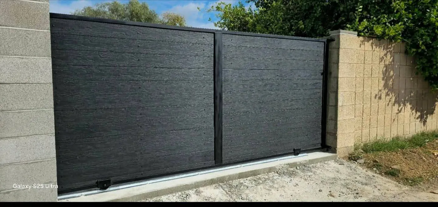 Dark wood sliding gate we built and installed