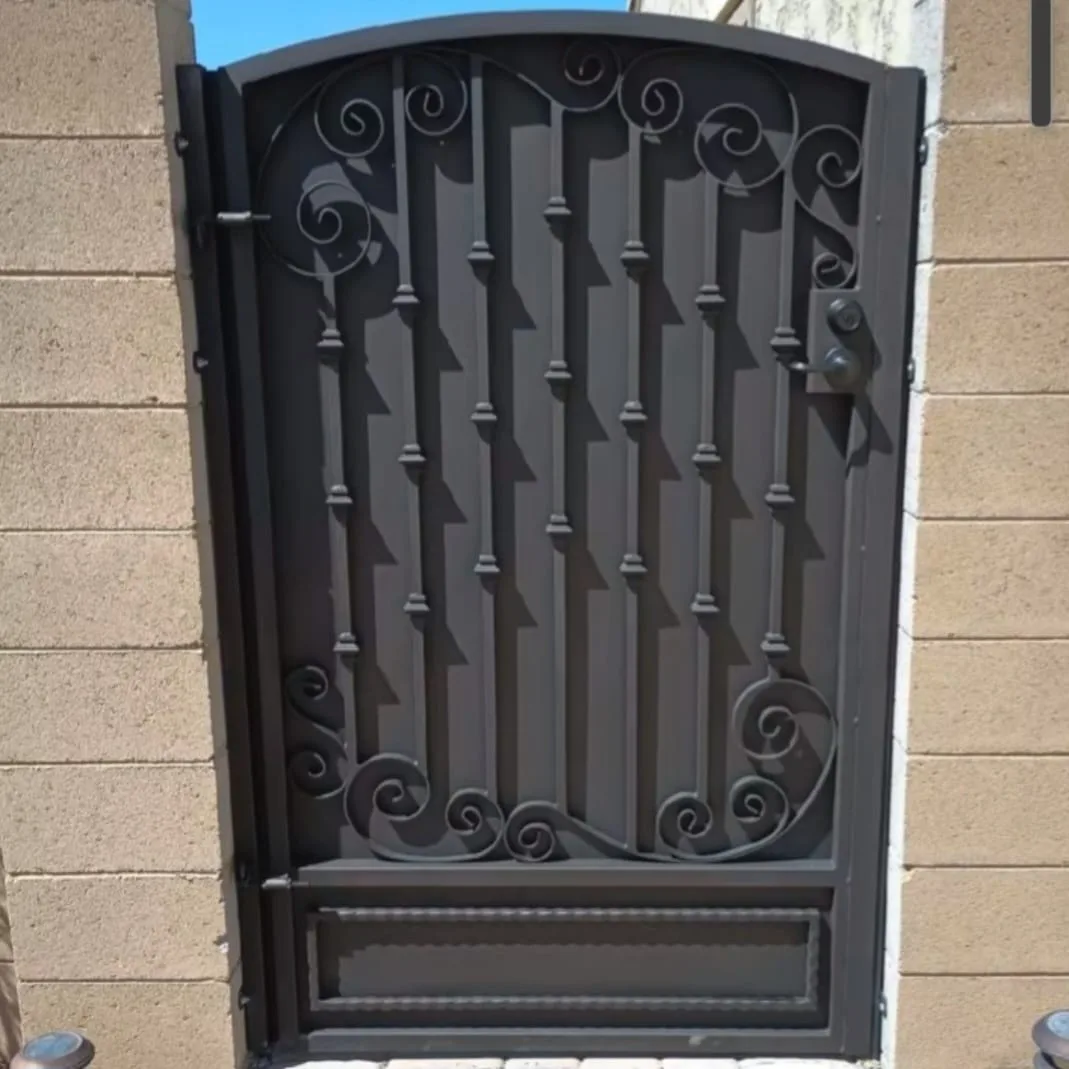 Custom iron entry door with scrollwork design